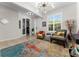 A cozy living room with tile floors, a vibrant rug, a modern chandelier, and stylish decor at 4862 Grand Vista Ln, St Cloud, FL 34771