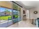 Bright living room with tile floors that opens to a covered patio and lush backyard at 4862 Grand Vista Ln, St Cloud, FL 34771