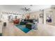 Open concept living space with tile floors, white kitchen, pendant lights, and view to bedroom at 4862 Grand Vista Ln, St Cloud, FL 34771