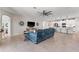 Spacious living room with tiled floors, a modern ceiling fan, and an open view of the kitchen at 4862 Grand Vista Ln, St Cloud, FL 34771
