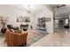 A cozy living room with tile floors, a vibrant rug, a modern chandelier, and stylish decor at 4862 Grand Vista Ln, St Cloud, FL 34771