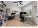A bright home office featuring a large window, a ceiling fan and plenty of workspace at 4862 Grand Vista Ln, St Cloud, FL 34771