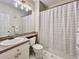 Classic bathroom features tile flooring, shower with a modern curtain, and vanity storage at 489 Water St # 489, Celebration, FL 34747