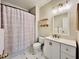 Clean bathroom with a shower and tub combination, white vanity, and updated lighting at 489 Water St # 489, Celebration, FL 34747