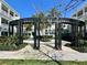 Relaxing outdoor community space with decorative metal structure, landscaping, and inviting walkways at 489 Water St # 489, Celebration, FL 34747