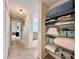 Hallway featuring a linen closet with built-in shelving for storage at 489 Water St # 489, Celebration, FL 34747