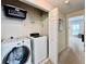 Efficient laundry room features modern appliances, shelving, and a convenient layout for easy chore management at 489 Water St # 489, Celebration, FL 34747