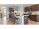 Modern kitchen with granite countertops, dark cabinetry, stainless steel appliances, and breakfast bar at 5215 Ligonberry St, Lakeland, FL 33811