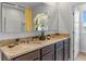 Double vanity bathroom with granite countertops, modern fixtures, and ample storage space at 5219 Ligonberry St, Lakeland, FL 33811