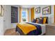 Stylish bedroom with a cozy bed, modern decor, a chalkboard wall, and natural light at 5219 Ligonberry St, Lakeland, FL 33811