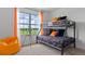 Fun bedroom featuring a bunk bed, bright colors, a telescope, and an orange beanbag chair at 5219 Ligonberry St, Lakeland, FL 33811