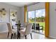 Cozy dining area with a glass table, chairs, and sliding glass doors to the backyard at 5219 Ligonberry St, Lakeland, FL 33811