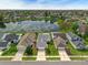 Aerial view of homes and a serene lake, showcasing the neighborhood's layout and landscaping at 5669 Parkview Lake Dr, Orlando, FL 32821