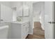 A well-lit bathroom features a modern vanity with gold hardware and a glimpse into an adjacent room at 5669 Parkview Lake Dr, Orlando, FL 32821