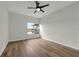 Neutral bedroom with wood-look flooring and a window overlooking the lake at 5669 Parkview Lake Dr, Orlando, FL 32821
