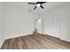 Neutral bedroom featuring wood-look floors, a ceiling fan, and a large closet at 5669 Parkview Lake Dr, Orlando, FL 32821