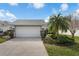 Charming single-story home featuring a two-car garage, well-maintained lawn, and mature landscaping at 5669 Parkview Lake Dr, Orlando, FL 32821