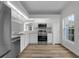 Bright kitchen with stainless steel appliances, white cabinets, and a view from the window at 5669 Parkview Lake Dr, Orlando, FL 32821