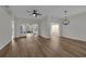 Open living room with wood-look flooring, a ceiling fan, and doors leading to a screened lanai at 5669 Parkview Lake Dr, Orlando, FL 32821