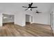 Open-concept living area with wood-look floors and views into the kitchen and sunroom at 5669 Parkview Lake Dr, Orlando, FL 32821