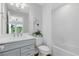 Inviting bathroom with modern fixtures, vanity with quartz countertop, and a shower-tub combo at 6006 Forest Perch Dr, St Cloud, FL 34771