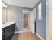 Modern bathroom with a walk-in shower, single sink vanity, and neutral color palette at 6006 Forest Perch Dr, St Cloud, FL 34771