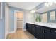 Stylish bathroom with dual sinks, dark cabinetry, and a large mirror at 6006 Forest Perch Dr, St Cloud, FL 34771