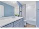 Bright bathroom boasts gray vanity with white counter and shower-tub combo with white tiling at 6006 Forest Perch Dr, St Cloud, FL 34771