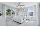 Bright bedroom with a ceiling fan, large windows offering scenic views, and neutral décor at 6006 Forest Perch Dr, St Cloud, FL 34771