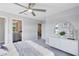 Cozy bedroom boasts a decorative mirror, a white dresser, and access to a well-lit bathroom at 6006 Forest Perch Dr, St Cloud, FL 34771