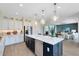 Open-concept kitchen with a large island, stainless steel appliances, and a view of the adjacent living area at 6006 Forest Perch Dr, St Cloud, FL 34771