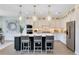 Modern kitchen featuring a center island with bar seating, white cabinets, and stainless steel appliances at 6006 Forest Perch Dr, St Cloud, FL 34771