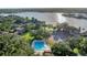 Aerial view of the community pool, tennis courts and lake surrounded by lush landscape at 638 Maple Oak Cir # 112, Altamonte Springs, FL 32701