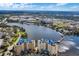 Aerial view of the community, lake, and surrounding urban area on a bright, sunny day at 638 Maple Oak Cir # 112, Altamonte Springs, FL 32701