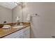 Bathroom featuring a granite countertop vanity, ample lighting, and a decorative mirror at 638 Maple Oak Cir # 112, Altamonte Springs, FL 32701