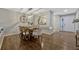 Bright dining room features an elegant chandelier, wood floors, and neutral wall paint at 638 Maple Oak Cir # 112, Altamonte Springs, FL 32701