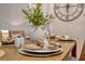 The dining table is elegantly set with charger plates, feather adorned napkins, and delicate glassware at 638 Maple Oak Cir # 112, Altamonte Springs, FL 32701