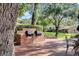 Outdoor grilling area with two grills, brick patio, mature tree, seating and green space at 638 Maple Oak Cir # 112, Altamonte Springs, FL 32701