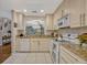 Beautiful kitchen with tile floors, white cabinets, granite countertops, and stainless steel appliances at 638 Maple Oak Cir # 112, Altamonte Springs, FL 32701