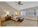 Bright and airy main bedroom with a ceiling fan and two large windows at 638 Maple Oak Cir # 112, Altamonte Springs, FL 32701