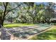 Outdoor shuffleboard courts surrounded by mature trees and seating area at 638 Maple Oak Cir # 112, Altamonte Springs, FL 32701
