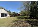 Large backyard with well-kept lawn, lush trees, patio furniture, and privacy fence at 691 Monroe Harbor Pl, Sanford, FL 32773