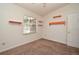 Bright bedroom featuring neutral carpet, white walls, a window view, and bright orange shelves at 691 Monroe Harbor Pl, Sanford, FL 32773