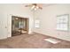 Inviting bedroom featuring neutral carpet, two windows offering natural light, and a sliding glass door to the lanai at 691 Monroe Harbor Pl, Sanford, FL 32773