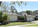Lovely single Gathering home featuring a lush green lawn, attached garage, and mature trees against a blue sky at 691 Monroe Harbor Pl, Sanford, FL 32773