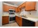 A traditional kitchen design with wood cabinets and stainless steel appliances at 691 Monroe Harbor Pl, Sanford, FL 32773