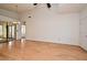 Large living room with gleaming wood floors and sliding glass doors to the screened patio, and a ceiling fan at 691 Monroe Harbor Pl, Sanford, FL 32773