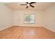 Inviting living room with gleaming hardwood floors, a ceiling fan, and a view of the entryway at 691 Monroe Harbor Pl, Sanford, FL 32773