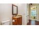 Powder room with granite vanity, fixtures, and dark wood floors at 7411 Excitement Dr, Reunion, FL 34747