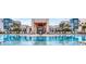 Stunning pool with plenty of lounge chairs, umbrellas and palm trees at a luxurious apartment complex at 7810 Spectrum Dr, Kissimmee, FL 34747